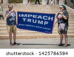 Small photo of Boston, MA / USA - June 15, 2019: Crowd of citizens protest to impeach President Donald Trump at rally held in front of the state capital building in Boston.