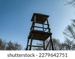 Wooden observation tower.Wooden observation tower in the forest.Wooden brown observation tower under the cloudy sky.