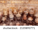 Collection of antique ancient clay jars, pots and bottles. Exhibition in an archeology museum. Selective focus.