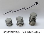 Small photo of Mumbai, India - 15 January 2021, Pile of coins showing growth, revenue, inflation, gdp, income, per capita, index, sensex, stock, share, price, savings, deposit, interest, market, bitcoin, investment.