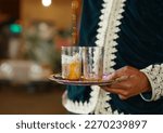 Small photo of Arabic Traditional Hospitality (Saudi Arabia). Bedouin lifestyle People. dallah is a metal pot with a long spout designed specifically for making Arabic coffee, Saudi coffee