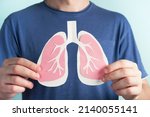 Small photo of Man holding lungs decorative model. World tuberculosis TB day, pneumonia, respiratory diseases concept. Closeup