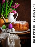 Small photo of Reindling - Austrian or German Easter festive yeasty baking. The egg rack next to the jug and the pink hyacinths on wooden background.