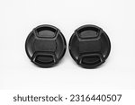 Small photo of Two black camera lens caps with a diameter of 52mm, designed to provide good protection for the camera front glass from dust, scratches and accidental damage.