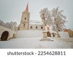 Peace snowy view on church, monument and empty square of UNESCO town Telč, Czech republic, Europe