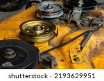Small photo of Lawn mower deck and new idler pulley. Lawn equipment maintenance repair
