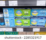 Small photo of Los Angeles, California, United States - 02-01-2023: A view of several cases of Omission Brewing beer cans, on display at a local grocery store.