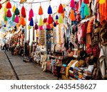Colorful alley with handmade souvenirs in traditional Pisac market, Sacred valley of Inca, Cusco region, Peru
