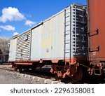 Small photo of Old Gray Steel Railroad Boxcar at the end of a Freight Train