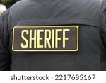 Small photo of Close up on Sheriff letters on back of flack jacket.