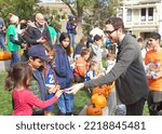 Small photo of San Francisco, CA - Oct 22, 2022: Senator Scott Wiener with participants at his Halloween Pumpkin Carving Event at Noe Courts park.