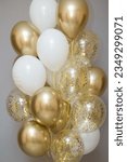 Small photo of shiny golden balloons with confetti, big bunch of helium balloons