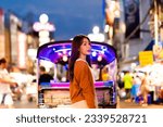 Happy Asian holiday travel vacation. Young woman outdoor city lifestyle shopping and eating street food together at Bangkok Chinatown street night market
