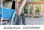 Small photo of Close-up of a senior sitting on a wheelchair at home Handicapped elderly man in a problematic wheelchair The concept of elderly people with disabilities