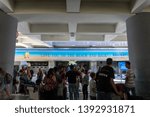Small photo of BADUNG/BALI-MARCH 28 2019:The atmosphere of hubbub in the pick up area of ​​the international airport in Ngurah Rai. Seen a tourist waiting for his picker. The area is decorated with interesting sign