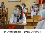 Small photo of BALI,INDONESIA-MAY 18 2021: Students in Indonesia are following the learning process in class using faceshields and health masks to implement health protocols during the COVID-19 pandemic