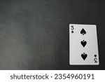 Small photo of ogan ilir,Indonesia-july 22th,2023: three of spade. rummy isolate on black background. selective Focus image