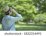Small photo of Asian young women. like spending time in the middle of nature. wear a hat at a rakish angle. blurred background with copy space.