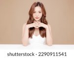 Small photo of Young Asian beauty woman curly long hair with korean makeup style on face and perfect skin on isolated beige background. Facial treatment, Cosmetology, plastic surgery.