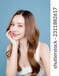 Small photo of Young Asian beauty woman curly long hair with korean makeup style on face and perfect clean skin on isolated blue background. Facial treatment, Cosmetology, plastic surgery.