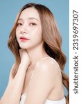 Small photo of Young Asian beauty woman curly long hair with korean makeup style on face and perfect clean skin on isolated blue background. Facial treatment, Cosmetology, plastic surgery.