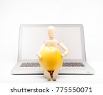 wooden man with computer take apple