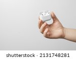 white wireless headphones in a male hand on a white background.
air pods pro
