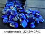 Small photo of blue gem Lapis lazuli lying on the floor