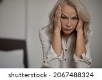 Small photo of Despondent blonde mature woman suffering from loneliness
