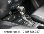 Small photo of automatic transmission shift selector in the car interior. Closeup a manual shift of modern car gear shifter. 4x4 gear shift