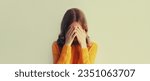 Small photo of Upset sad crying woman covering her eyes with her hands while experiencing mental or physical suffering