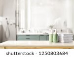 Ceramic shampoo, soap bottle and towels on counter over bathroom background. table top and copy space