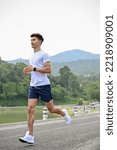 Small photo of Portrait, Handsome athletic fit young Asian man in sportswear concentrating on running outdoors in the morning.
