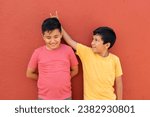 Small photo of 9-year-old Latino children get upset and bully each other as a form of physical, psychological, verbal and social abuse among students