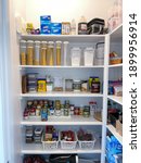 Small photo of Orlando,FL USA - January10, 2021: A home pantry that is organized with various products in put away in a tidy manner.