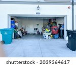 Small photo of Orlando, FL USA - September 3, 2021: An unorganized garage filled with a lot of stuff in a neighborhood.