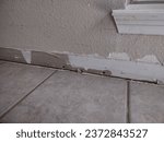 Small photo of Preparing baseboards after removing old baseboards; installing baseboards after flooring