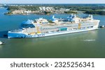 Small photo of Turku, Finland - June 19 2023: Worlds largest cruise ship ICON OF THE SEAS departing for sea trials from Meyer Turku shipyard assisted by tug boats. Aerial side view.
