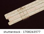 Small photo of Logarithmic ruler on a wooden table. Stationery for engineers and students. Logarithmic Slide Rule.