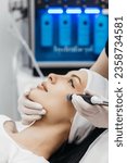 Small photo of Perfect cleansing. Face of a beautiful pleasant woman being cleansed during hydrafacial procedure