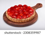 Brazilian strawberry pie on a round granite board on white background for clipping mask