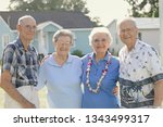 Small photo of Erath, L.A. / USA - MAY 28, 2014: Four caucasian senior citizens standing together. Nonagenarian and Octogenarian people smiling and hugging in a group outdoors all wearing glasses on a summer day.