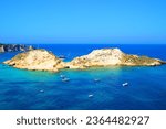 Small photo of Charming scenery from Tremiti Islands (Isole Tremiti) with lucid expanses of deep blue and azure Adriatic Sea punctuated by motorboats, a balmy island in the middle, rocky spurs in the background