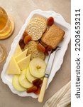 Small photo of Charcutierie plate with salted, crip cookies crackers, cheese and apples slices. Party or snack food