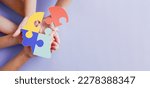 Small photo of Hands holding jigsaw puzzle head shape, Autism awareness, Autism spectrum disorder (ASD), World Autism Awareness Day