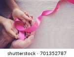 Adult and child hands holding pink ribbons, Breast cancer awareness, abdominal cancer awareness and October Pink day background, world cancer day
