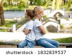 Small photo of Children take offense at each other in the park on a bench.