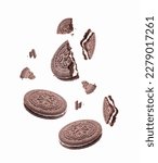 Small photo of Chocolate cookies or biscuits, with vanilla cream filling, falling on white background