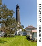 Pensacola Lighthouse, a historic lighthouse at Naval Air Station Pensacola, Florida.  Concepts could include history, tourism, nautical themes, navigation, other.  Vertical orientation.