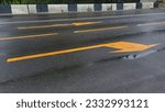 Yellow arrows of road markings...